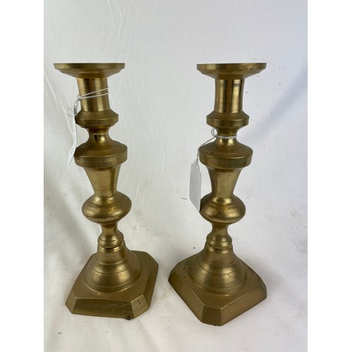 369 - Pair of brass candlesticks with pushers