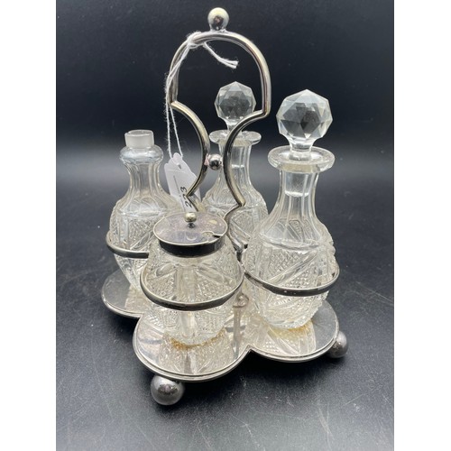 223 - A Victorian 4 piece cut glass cruet set on EPNS