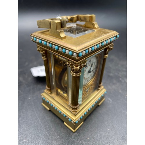 227 - Miniature Victorian windup carriage clock heavily decorated and with beveled glass , 3'5''h, heavy t... 