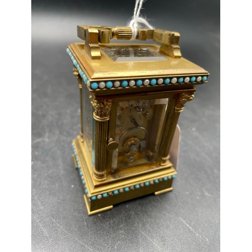 227 - Miniature Victorian windup carriage clock heavily decorated and with beveled glass , 3'5''h, heavy t... 