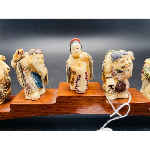 110 - A collection of Chinese Gods, hand carved and hand painted figures mounted (7)