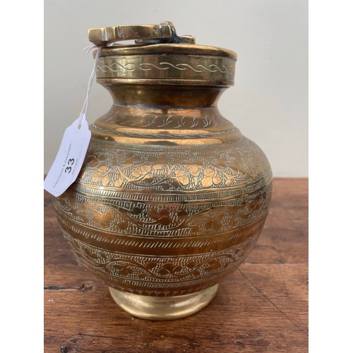 33 - Heavy brass urn with lid, decoratively engraved, 10''h