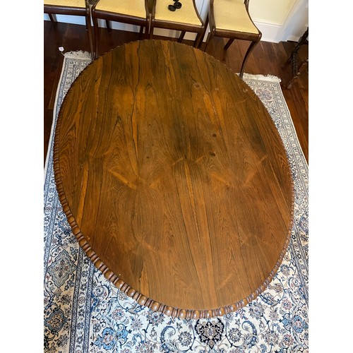 119 - A magnificent Georgian Irish tilt top, rosewood dining table on a centre pod with hairy claw feet wi... 