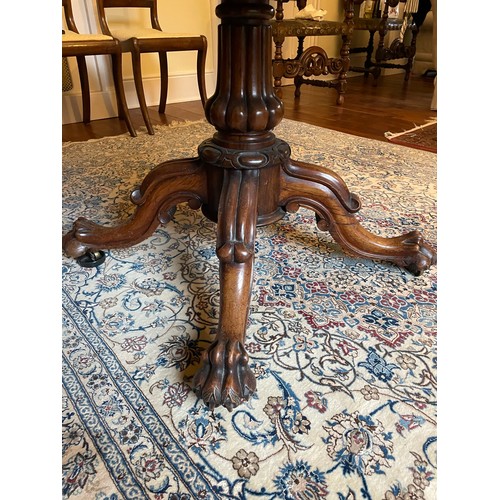 119 - A magnificent Georgian Irish tilt top, rosewood dining table on a centre pod with hairy claw feet wi... 