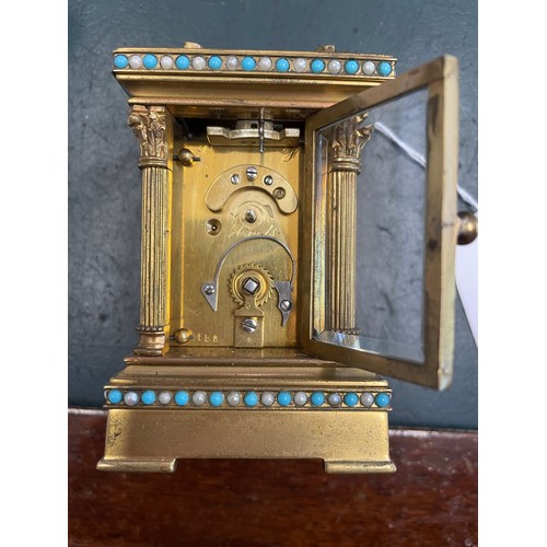 227 - Miniature Victorian windup carriage clock heavily decorated and with beveled glass , 3'5''h, heavy t... 