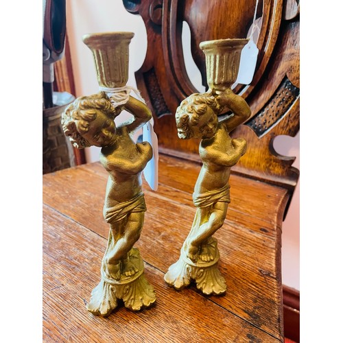 100 - A pair of cherub wood carved gilt candle sticks, 8''h