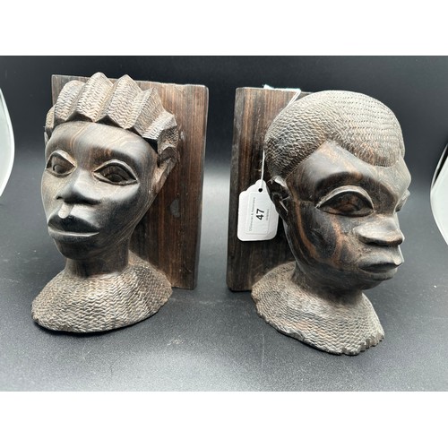 47 - A pair of African carved heavy bookends, 7.5''h