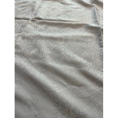 180 - Large Irish linen table cloth depicting Celtic Cross, Round Tower Harp etc. 68'' x 104''