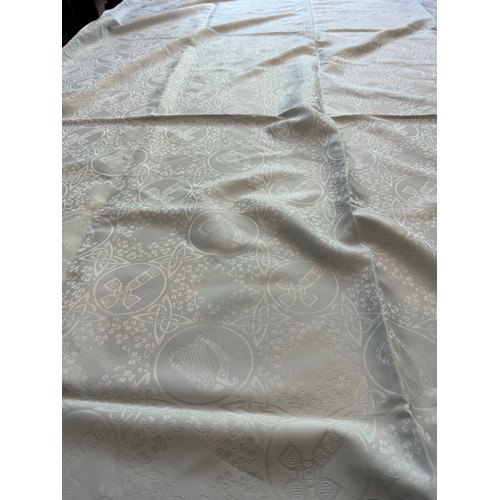 180 - Large Irish linen table cloth depicting Celtic Cross, Round Tower Harp etc. 68'' x 104''