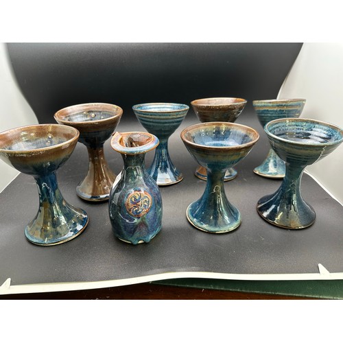 437 - A collection of 8 Irish pottery goblets and a Colm de Ris jug 8''h