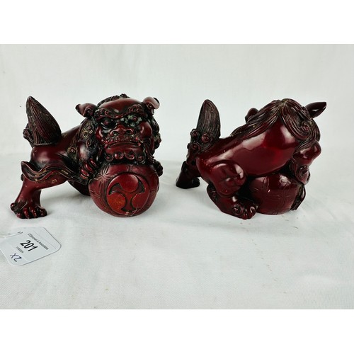 201 - A pair of oriental Foo dogs heavily carved and very decorative. Possibly 19th century or earlier. 4.... 