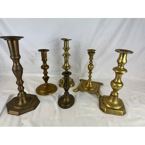 33 - A collection of 6 brass candlesticks