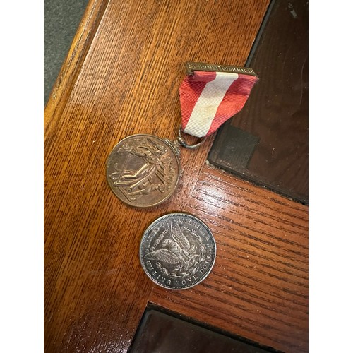 85 - 1921 US one dollar silver coin and 1945 Irish Emergency medal