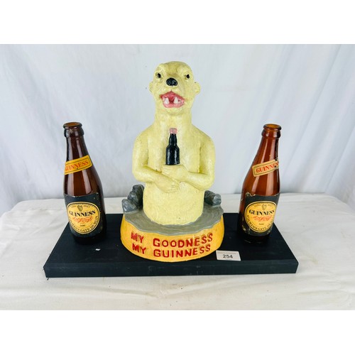 254 - MY GOODNESS MY GUINNESS POLAR BEAR  ADVERTISING RESINFIGURE
MOUNTED ON WOOD WITH 2 OLD GUINNESS BOTT... 