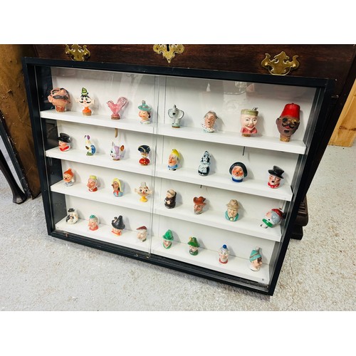 255 - 32 BOTTLE WHISKEY POURERS WITH A 4 SHELF DISPLAY CABINET, EARLY 1900'S 34''W X 4''D X 24'', PAPER MA... 