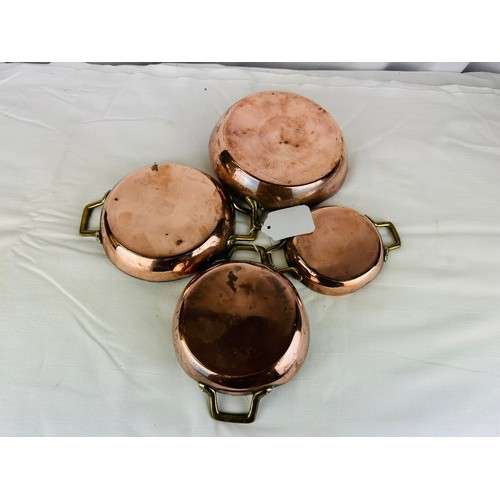 57A - A SET OF 4 GRADUATED SIZES COPPER AND BRASS DISHES