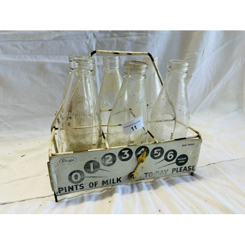 11 - WIRE MILK HOLDER CONTAINING 6 MILK BOTTLES