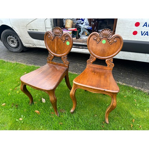 380 - A pair of solid oak hall chairs with carved backs, excellent condition. 18'' seat h