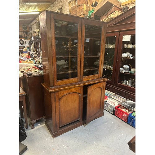 393 - 4 door oak bookcase with adjustable shelves. Comes in 2 parts