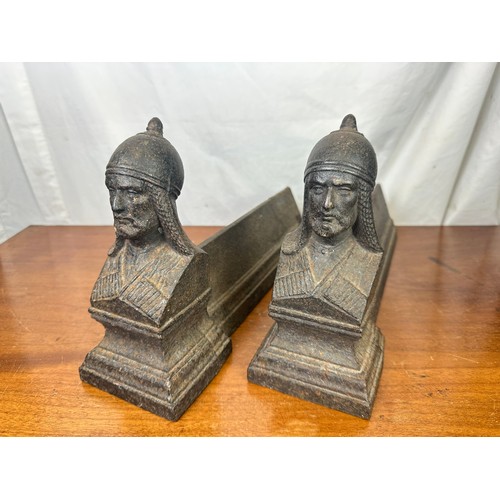 401 - A pair of heavy cast iron fire dogs with Roman soldiers on each