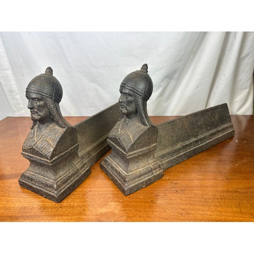 401 - A pair of heavy cast iron fire dogs with Roman soldiers on each