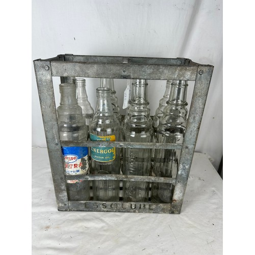 471 - A collection of 8 vintage embossed oil bottles with carry crate