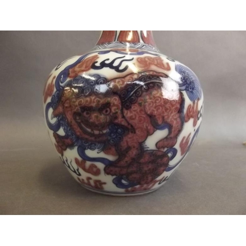 19 - A Chinese porcelain long necked vase decorated with blue and white kylin with iron red highlights, 4... 