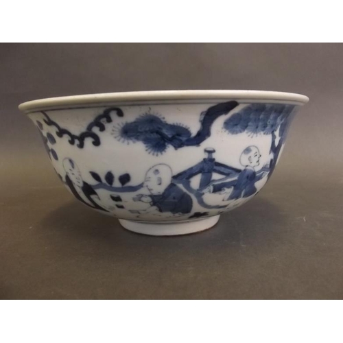 21 - A Chinese blue and white porcelain bowl decorated with boys in a garden, 6