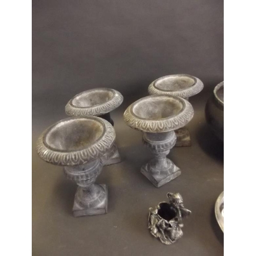 24 - Four small lead classical urns, a pewter fruit bowl, two silver plate pedestal bowls, a candlestick ... 