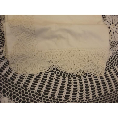 29 - A circular lace table cloth, and a king size lace edged bedspread, cloth 60