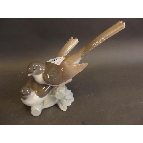 32 - A Lladro figure of two house martins on a branch, no. 4667 (retired 1985), a Lladro figure of a duck... 