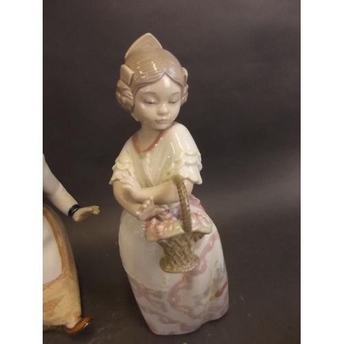 37 - A Spanish Zaphir porcelain figure of a young girl with a basket of flowers, with original box, and a... 