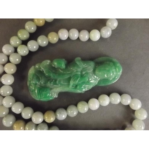 45 - A small carved jade figure of Quan Yin, and a string of jade beads, figure 2½