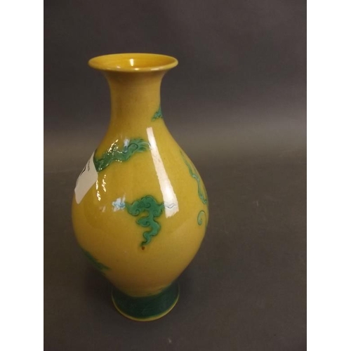 47 - A Chinese porcelain vase with green dragon decoration on a yellow ground, seal mark to base, 6