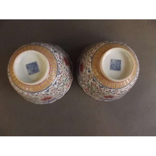 51 - A pair of Chinese porcelain bowls with flared rims decorated with flowers in bright enamels, seal ma... 