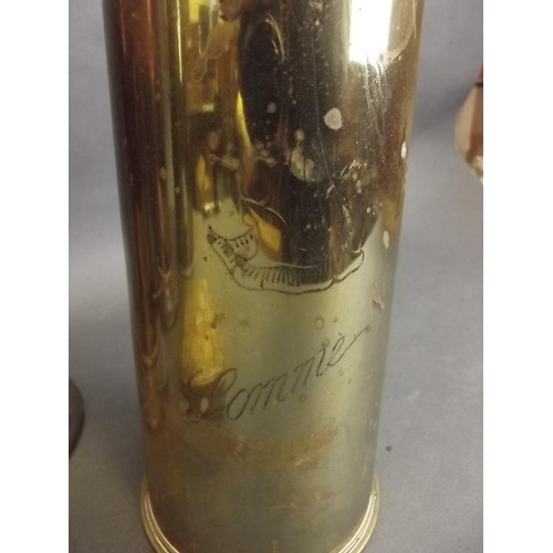 58 - A collection of WWI memorabilia to include two brass shell case vases engraved 'Somme', a Christmas ... 