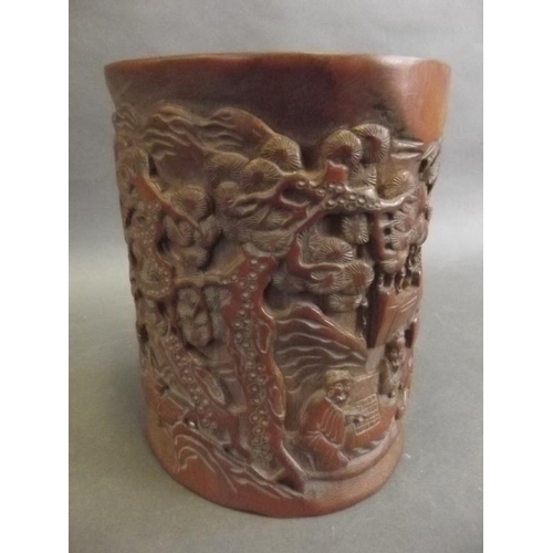 7 - A Chinese carved bamboo brush pot decorated with figures in a garden, 6½