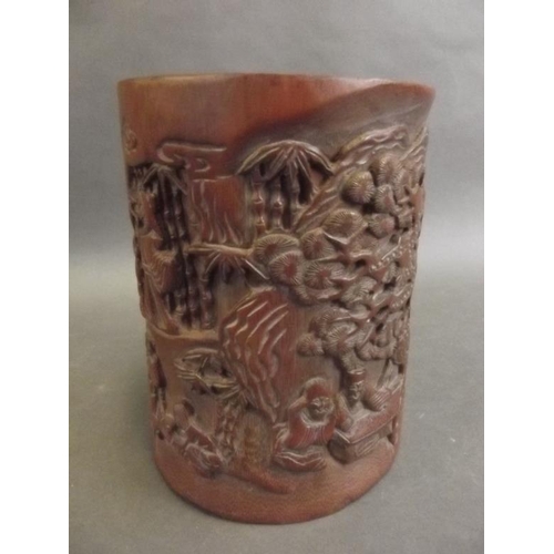 7 - A Chinese carved bamboo brush pot decorated with figures in a garden, 6½