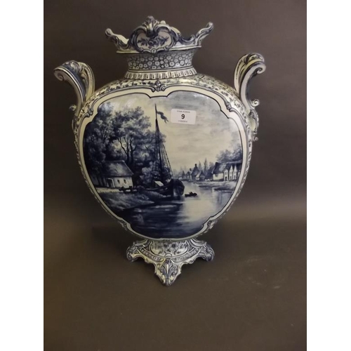 9 - A large Delft twin handled blue and white moon vase decorated with a river landscape, 18½