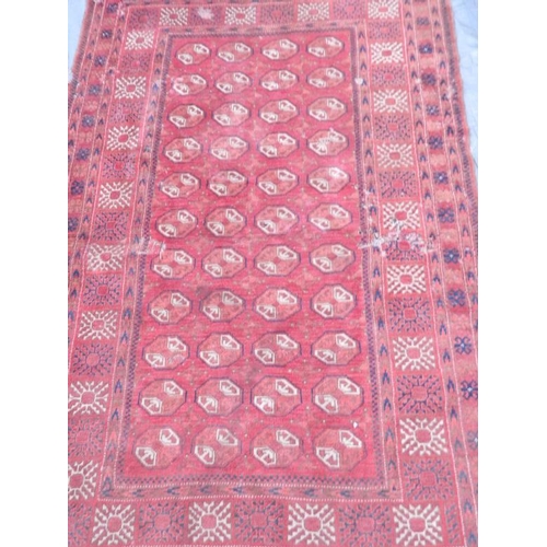 902 - A Persian wool rug with geometric design on a red field, early C20th, 80'' x 50'' (AF)