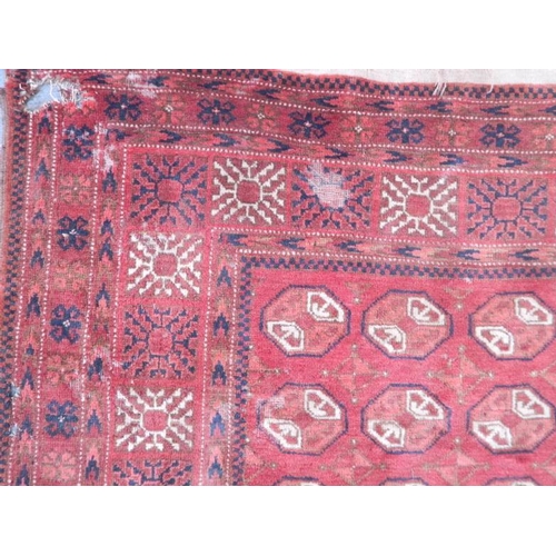 902 - A Persian wool rug with geometric design on a red field, early C20th, 80'' x 50'' (AF)