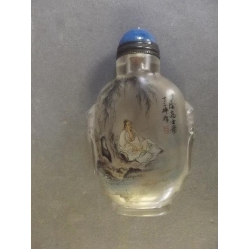 2 - A Peking glass snuff bottle with reverse painted decoration of a gentleman in a landscape, signed wi... 