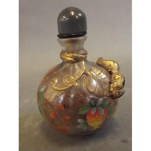 20 - A Peking glass snuff bottle with applied gilt decoration of a squirrel amongst vine leaves, and pain... 