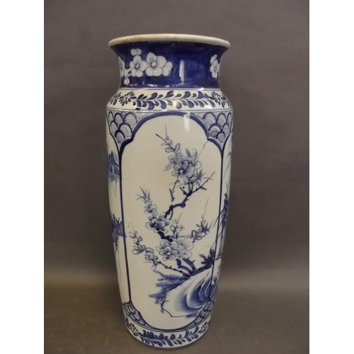 21 - A Chinese blue and white porcelain cylindrical vase decorated with flowering trees and bamboo, signe... 