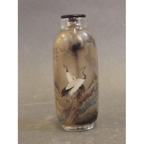 41 - A Peking glass snuff bottle with reverse painted decoration of cranes in a landscape, 3