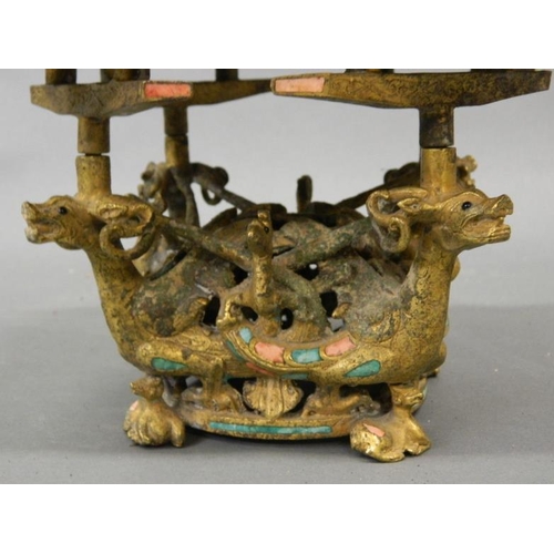 49 - An Oriental gilt bronze stand on dragon supports and phoenix mounts, inset with turquoise, 8