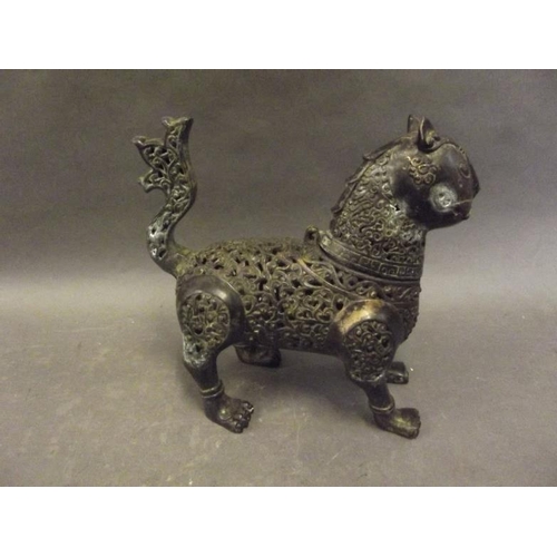 61 - A Persian iron incense burner in the form of an exotic beast with pierced scrolling decoration