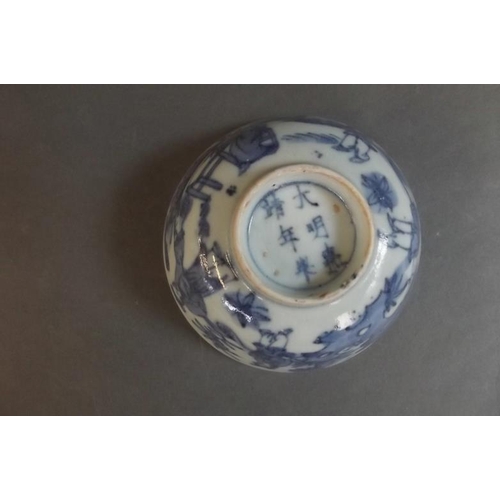 62 - A Chinese blue and white porcelain rice bowl decorated with figures in a landscape, 6 character mark... 