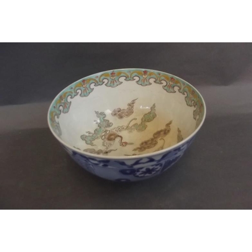 65 - A Japanese blue and white porcelain bowl decorated with panels of landscapes, flowers and symbols, t... 