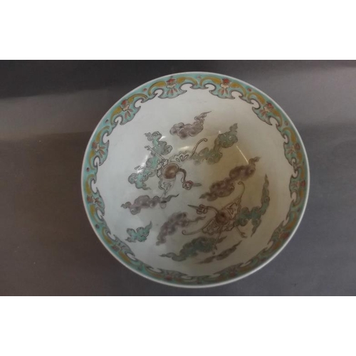 65 - A Japanese blue and white porcelain bowl decorated with panels of landscapes, flowers and symbols, t... 